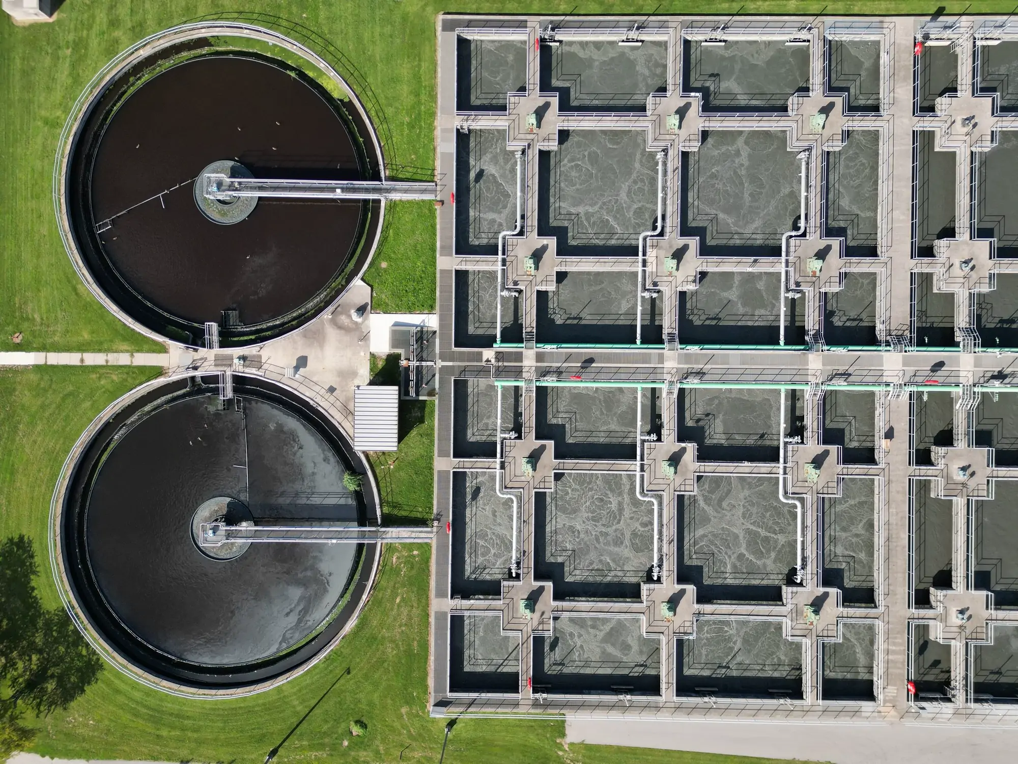 Water treatment infrastructure at dusk, concrete channels running into the distance