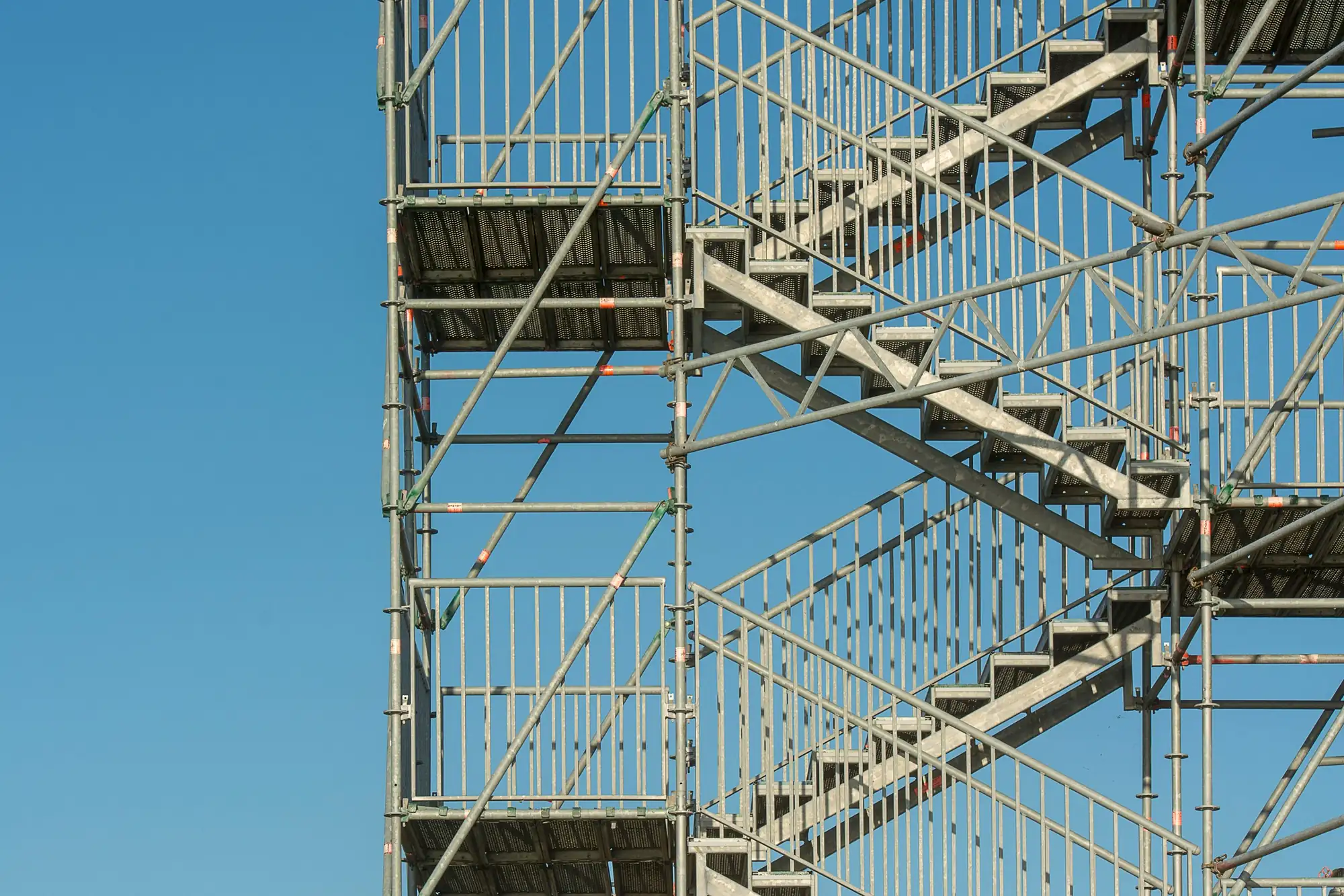 Scaffolding and stair towers erected around a building under construction.
